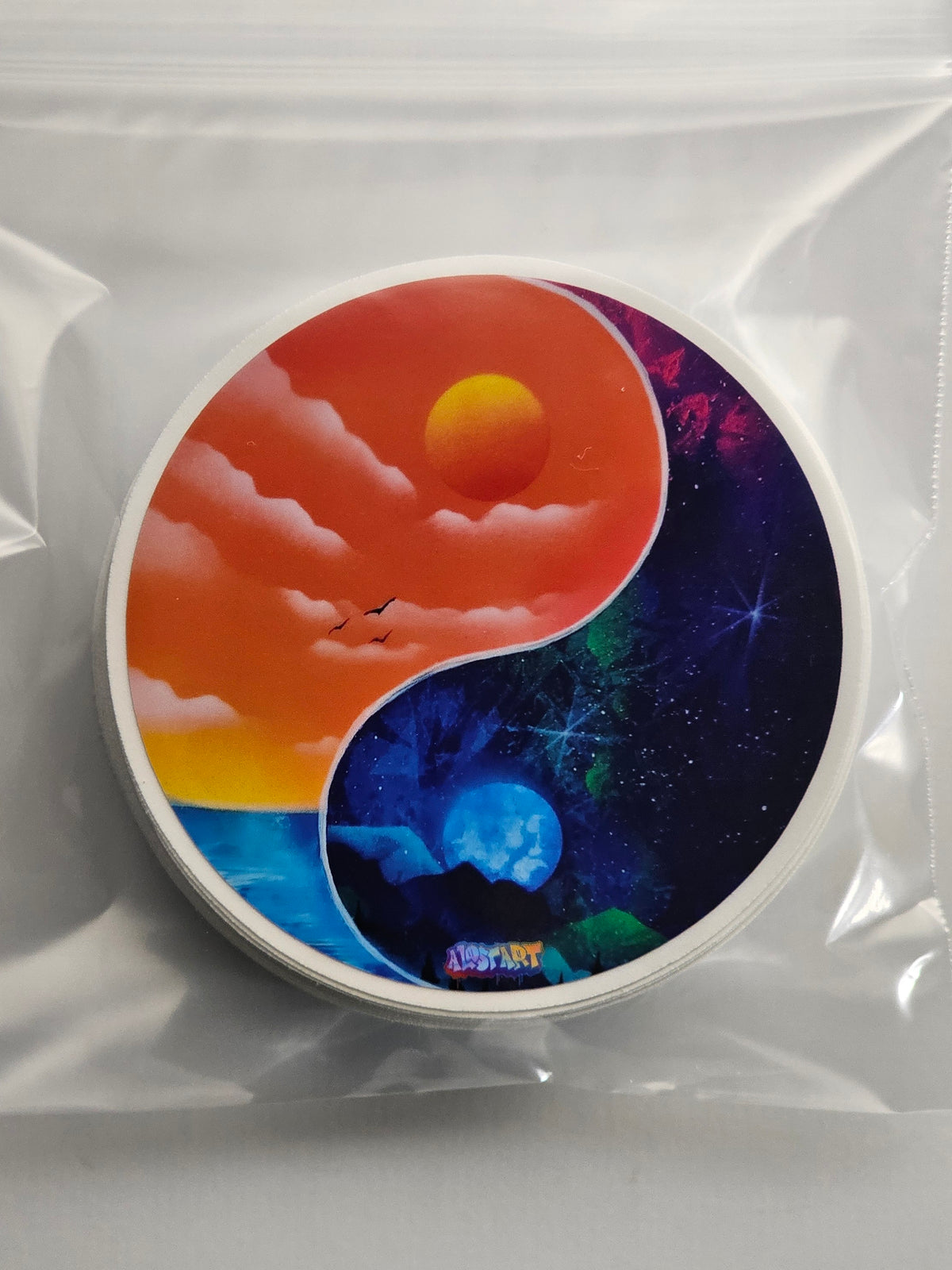 Yin yang design with sunset and space scene on a white background