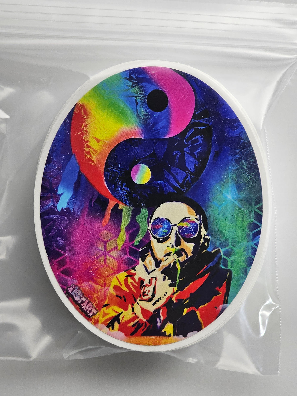 Colorful circular design with a portrait, yin yang symbol, and abstract elements on a clear background.