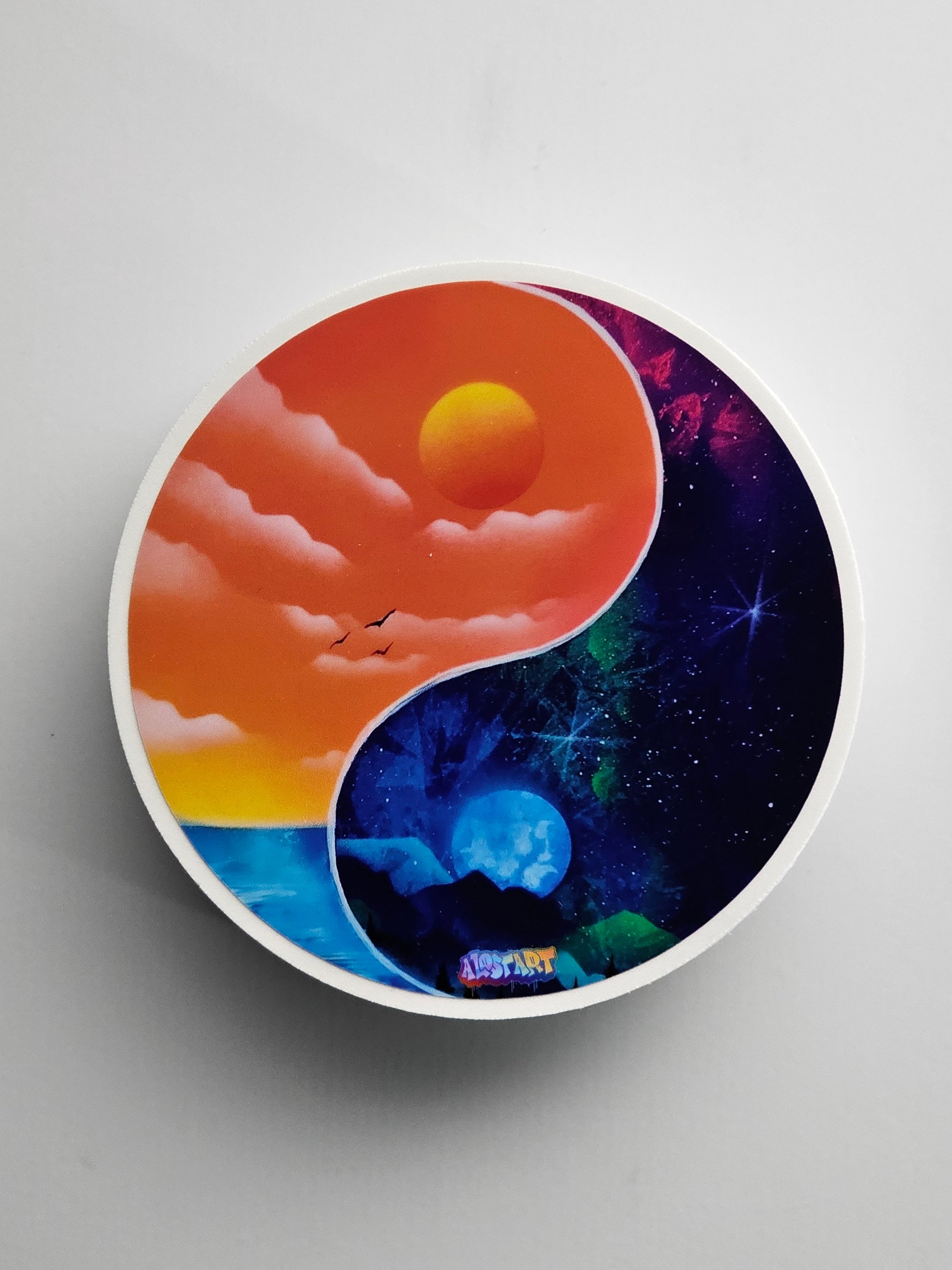 Yin yang design with sunset and space scene on a gray background
