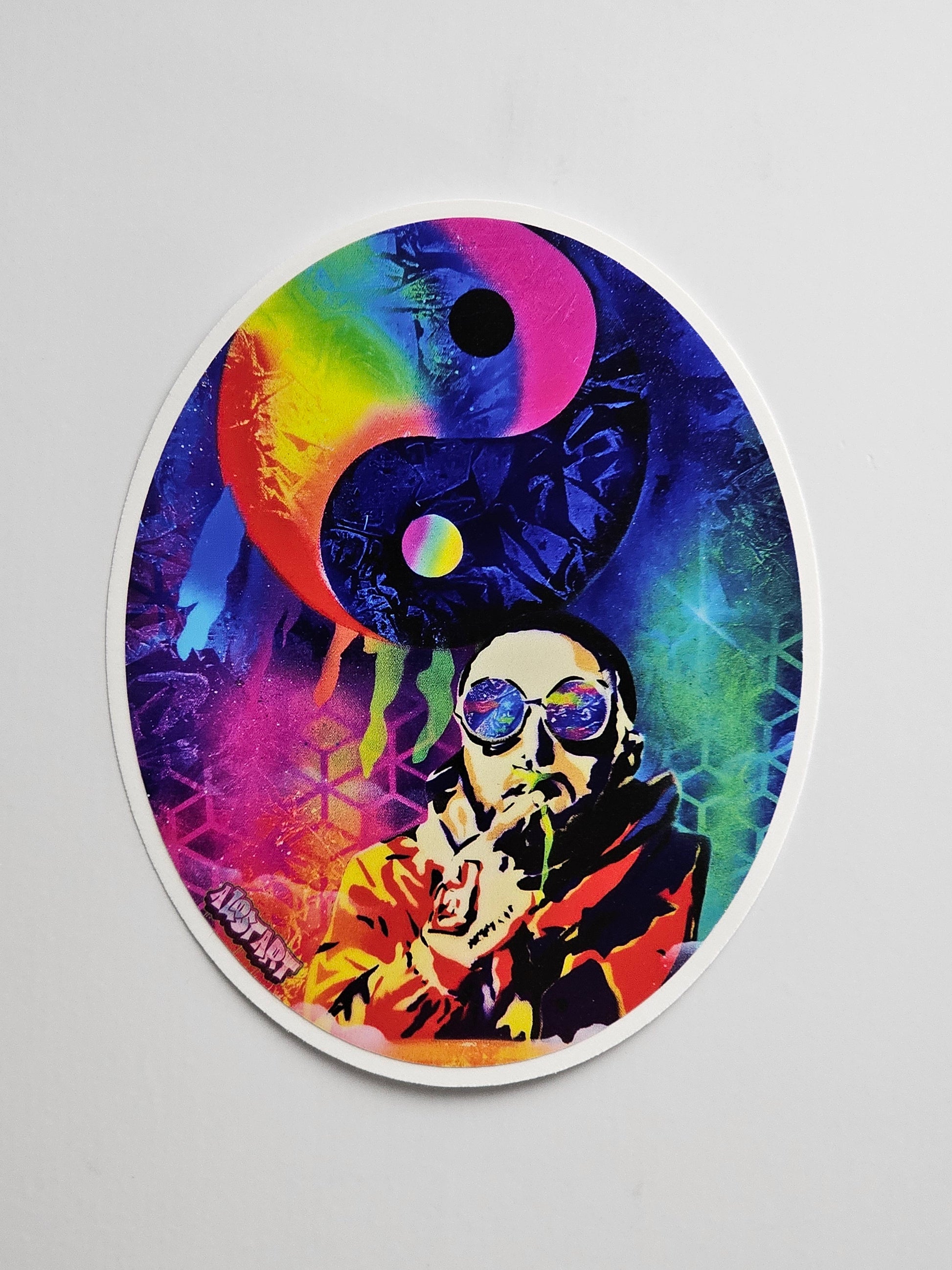 Colorful sticker with a yin yang symbol and artistic design on a gray background