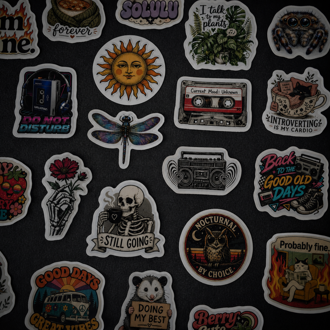 Custom die cut vinyl stickers displayed on dark tabletop