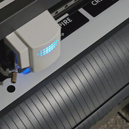 Video of bumper stickers being cut on an industrial cutter machine.